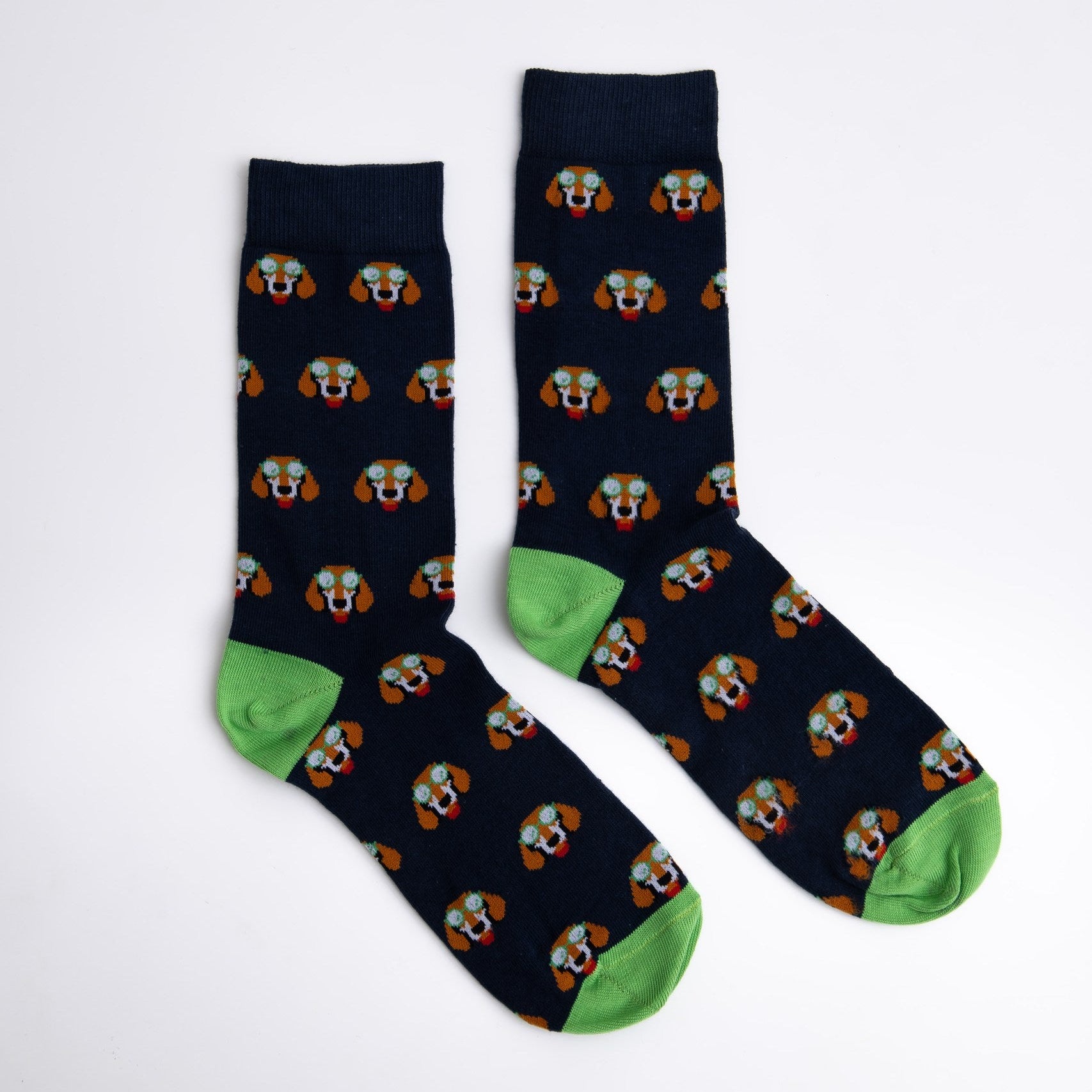Pair of navy socks with dog pattern and green toes on a white background