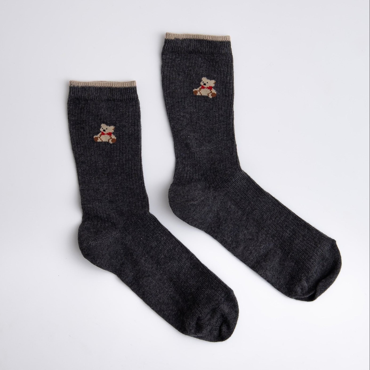 Pair of dark gray socks with embroidered designs on a light gray background

