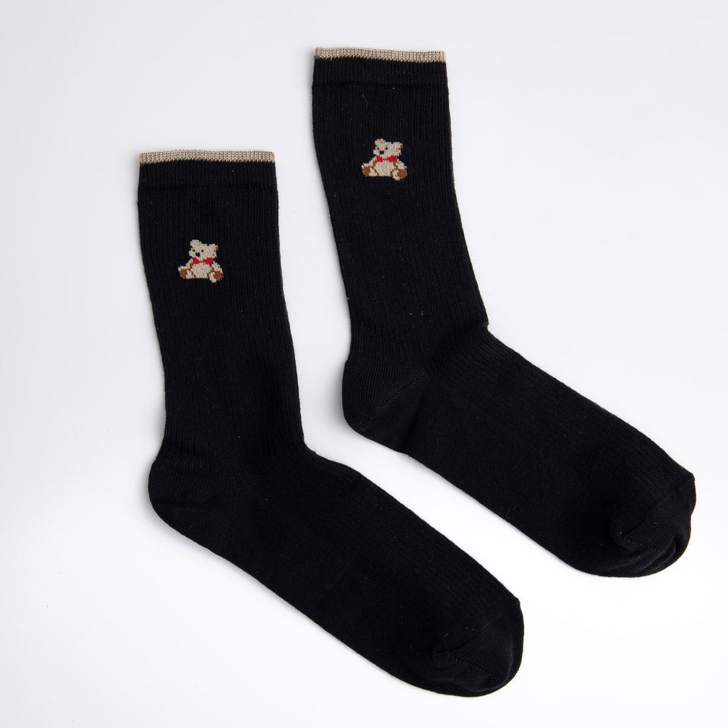 Two black socks with embroidered designs on a white background

