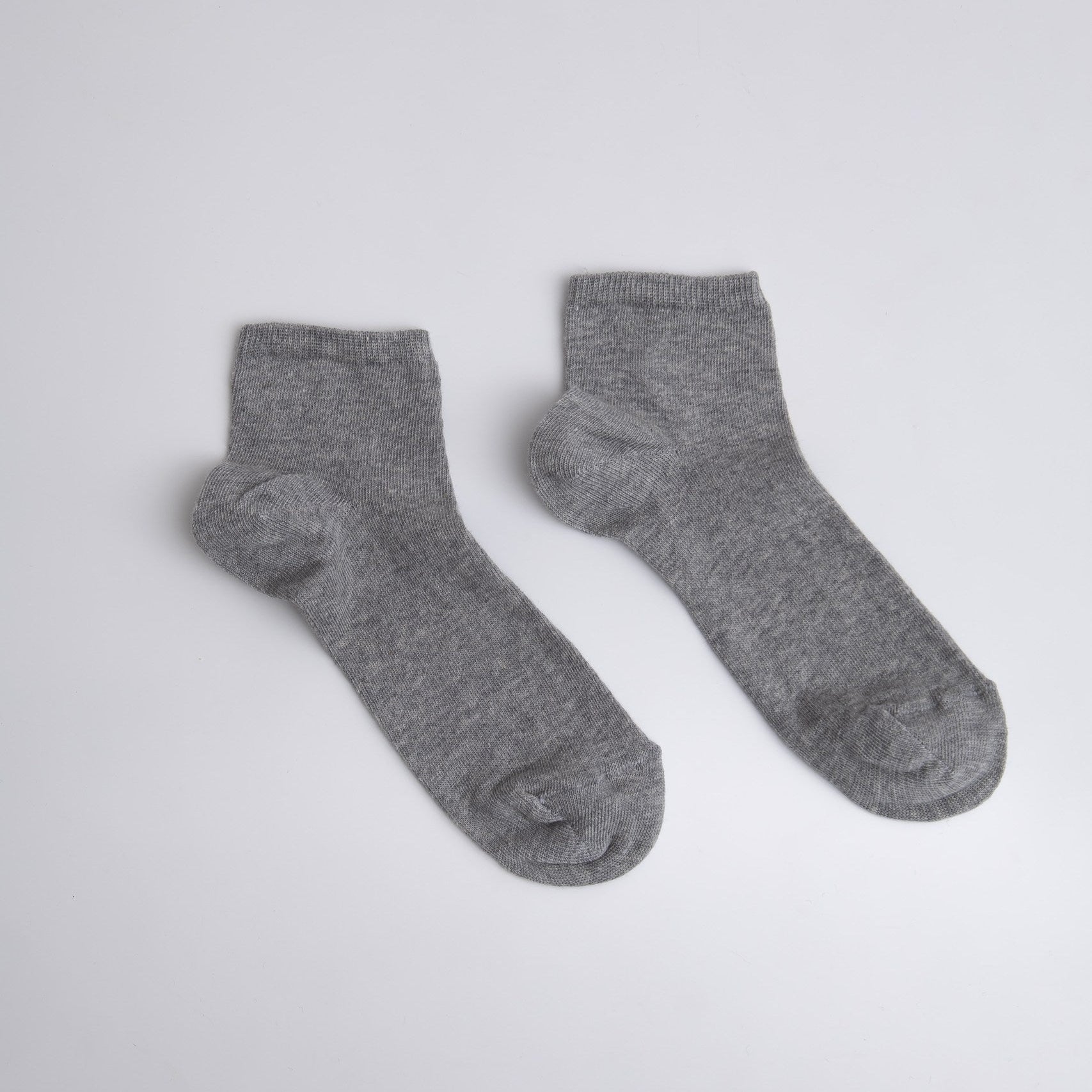 Pair of gray socks on a light gray background / buy socks in Prague

