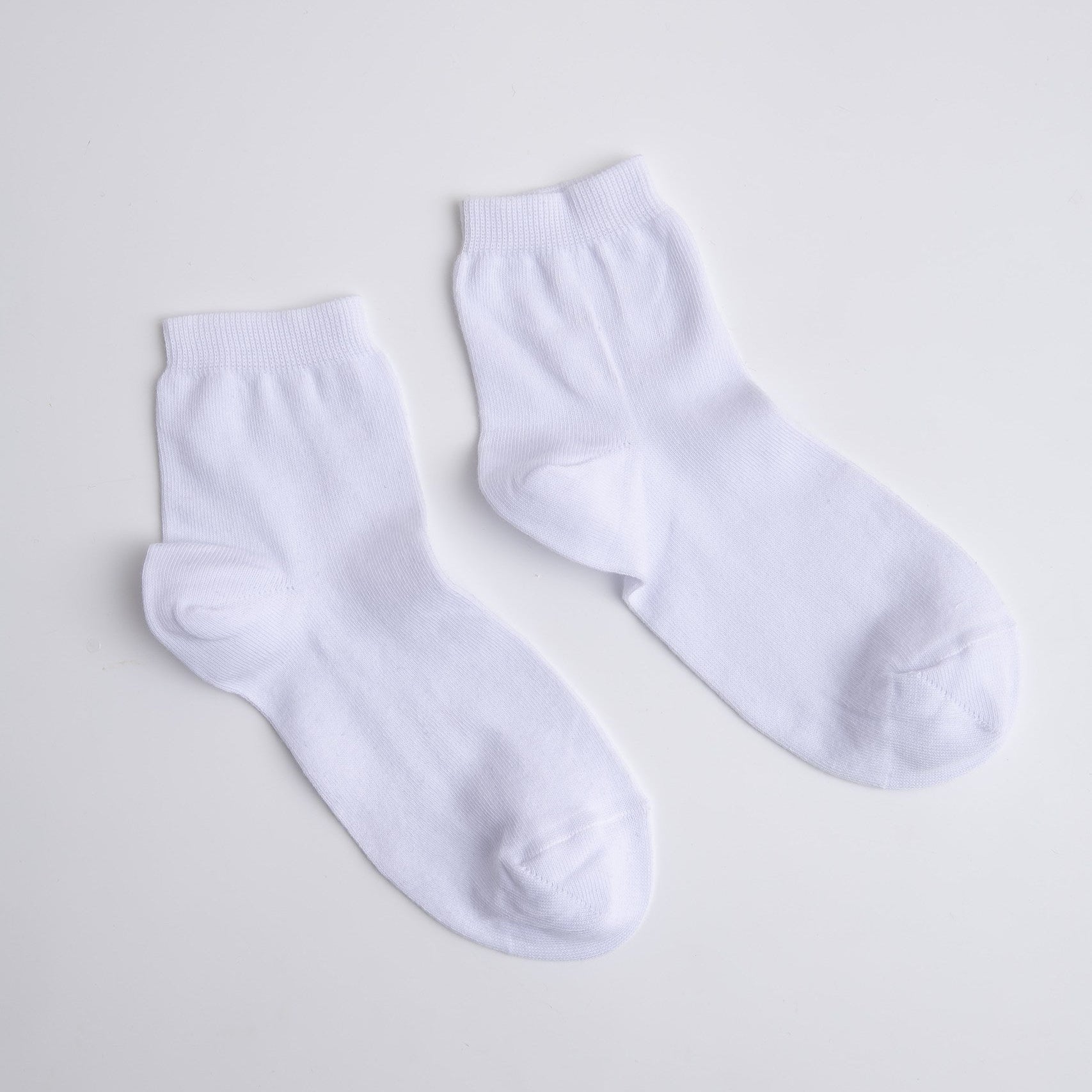 Two white socks on a light gray background buy socks in Prague 