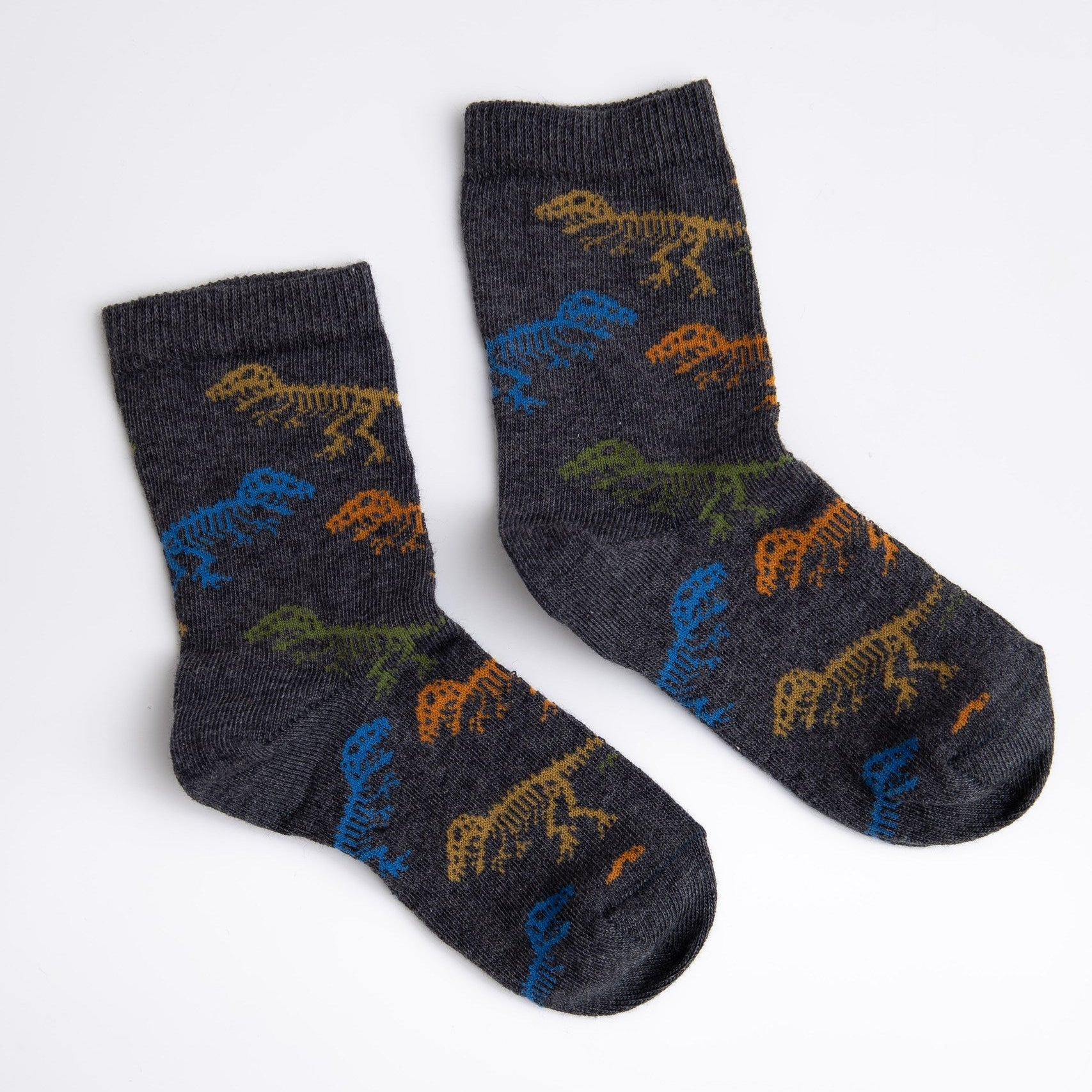 Pair of dark gray socks with dinosaur skeleton patterns on a white background

