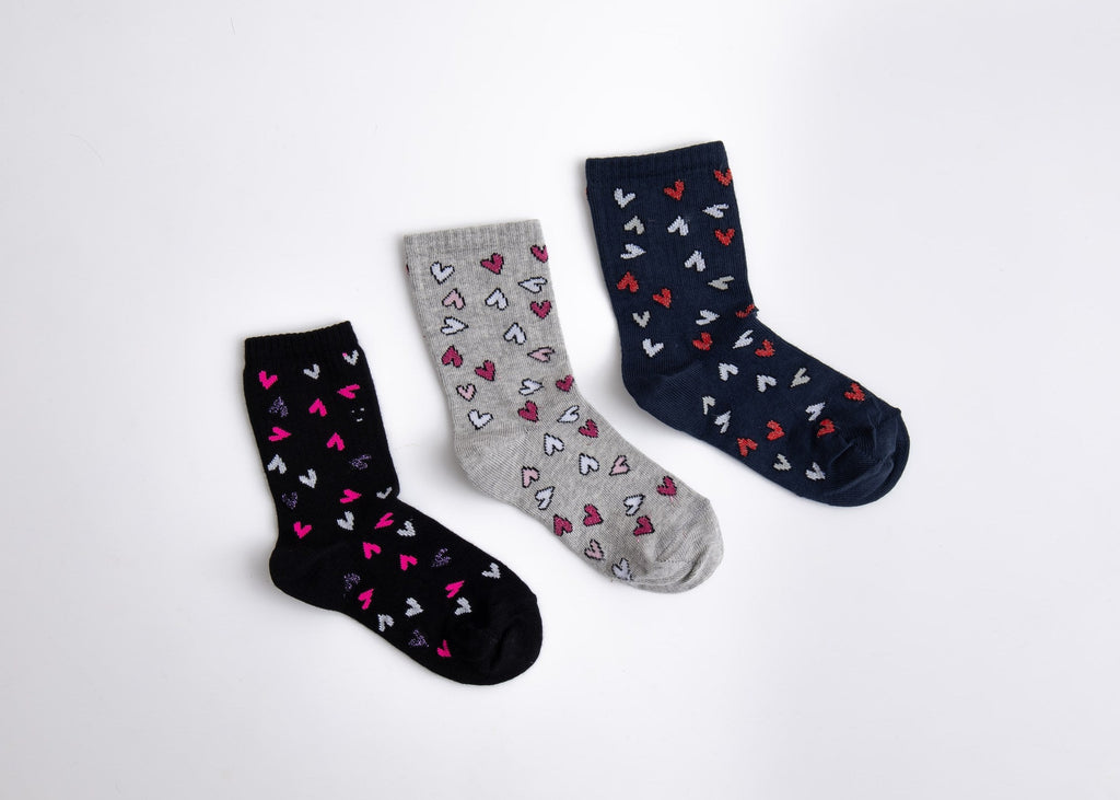 Three pairs of socks with heart patterns on a white background

