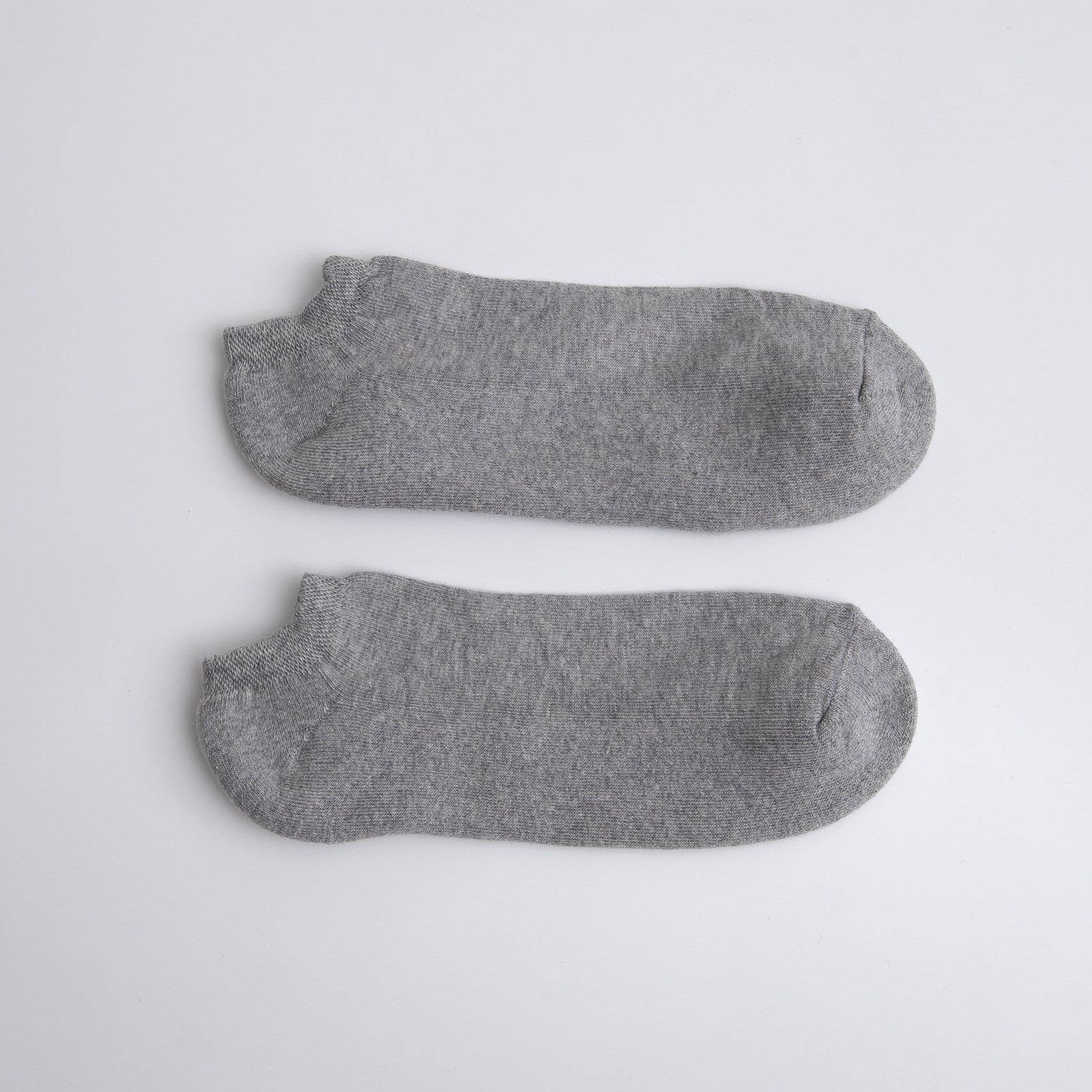 Two gray ankle socks on a light gray background

