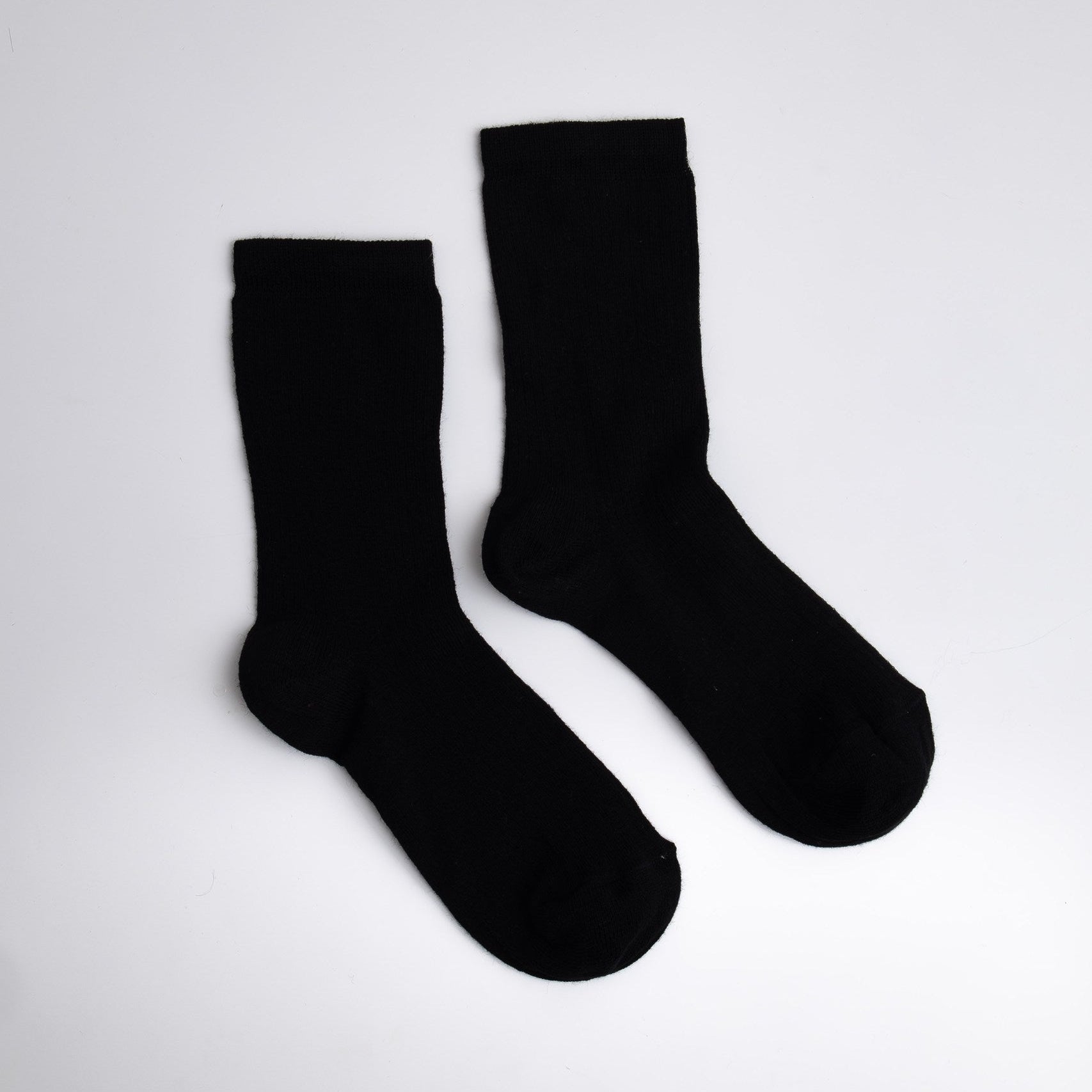 Pair of black socks on a white background

