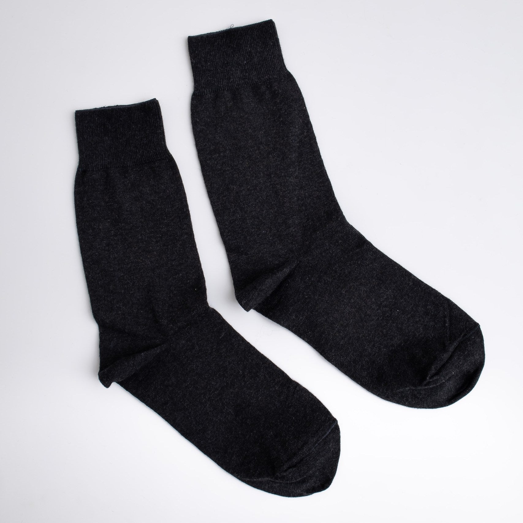 Pair of black socks on a white background

