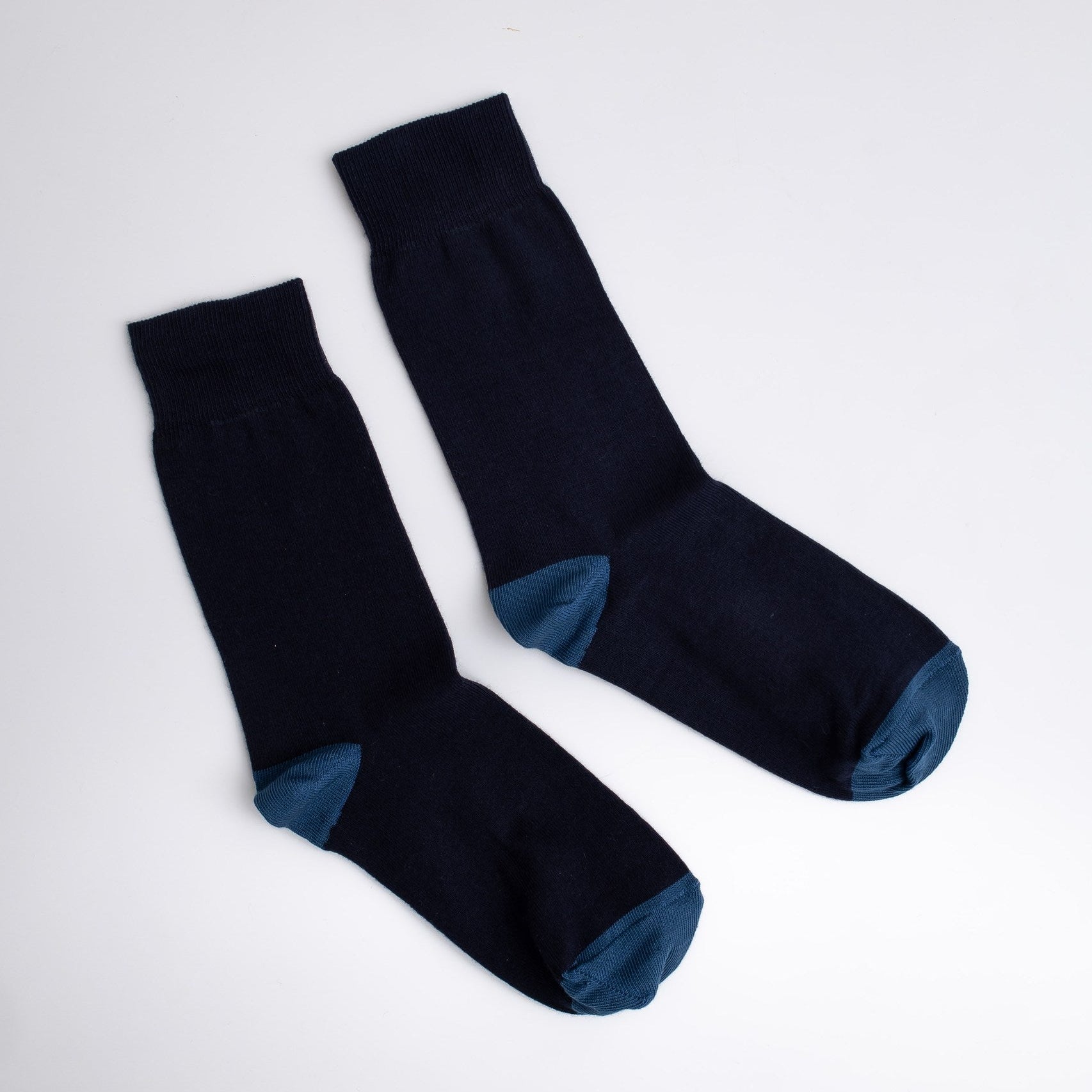 Pair of black socks with blue toes and cuffs on a white background

