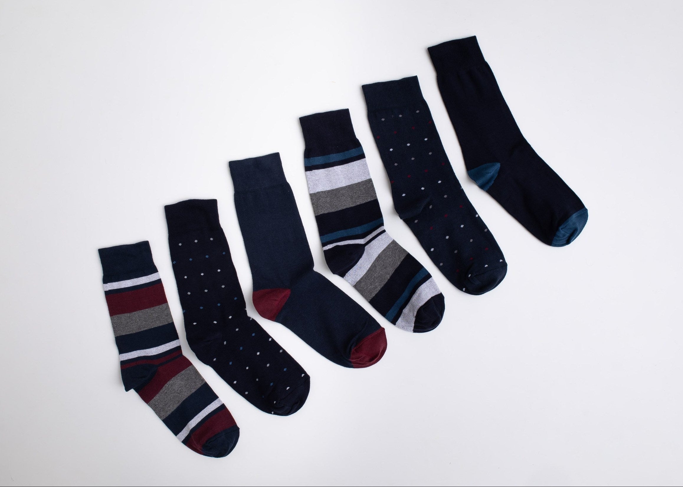 Set of dark blue patterned socks on a light gray background

