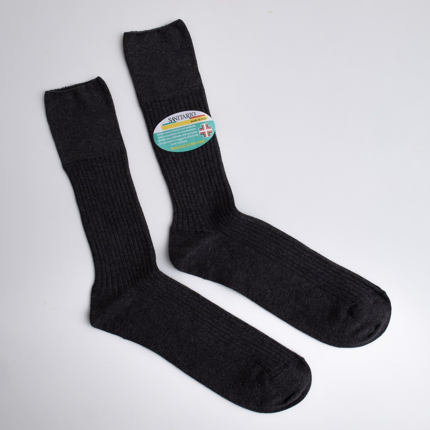 Pair of black socks with a visible brand label on a light gray background

