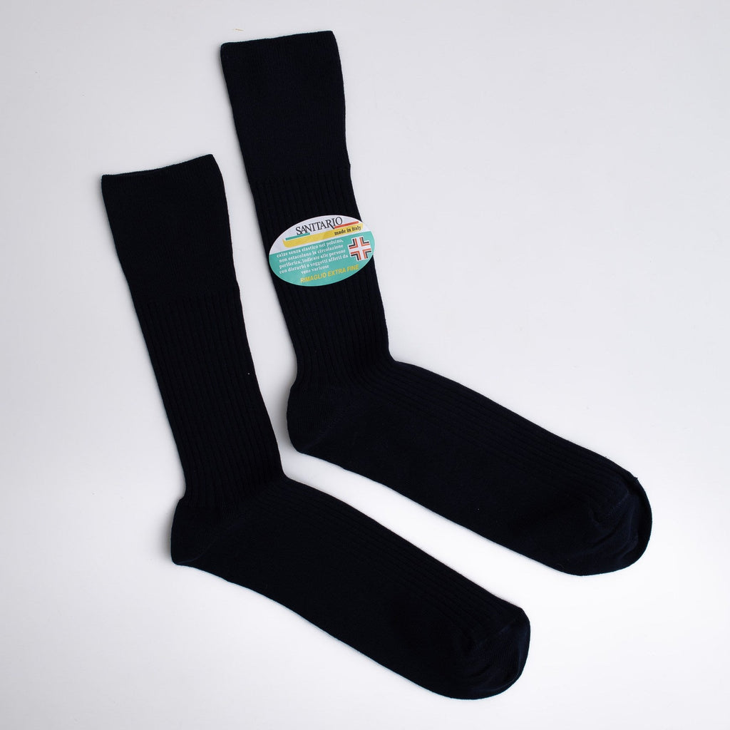 Black socks with a visible brand label on a light gray background

