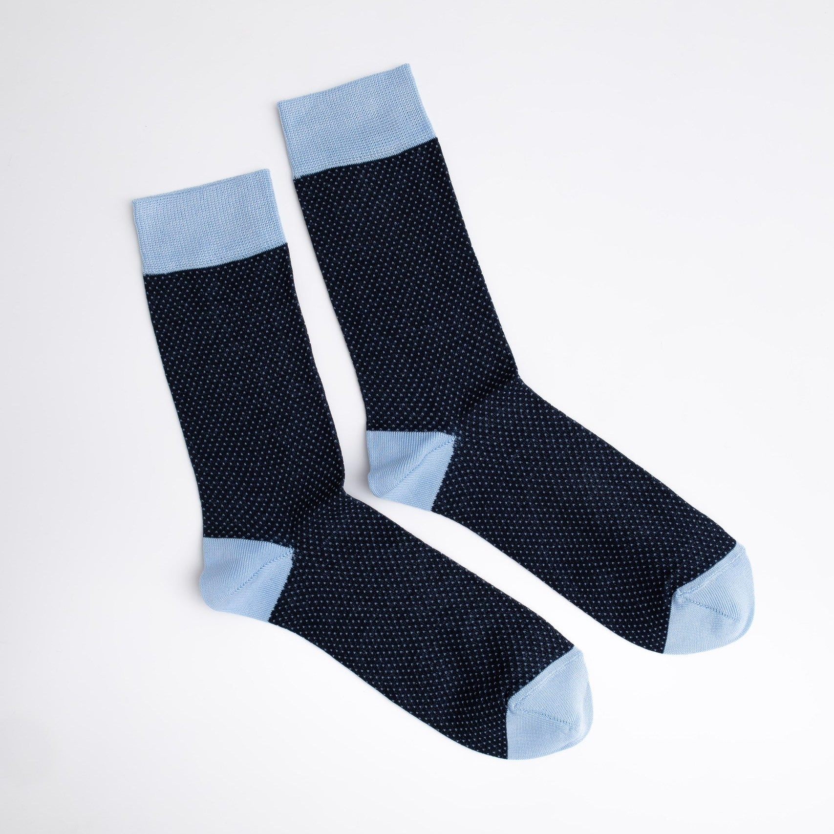 Pair of black socks with light blue accents on a white background

