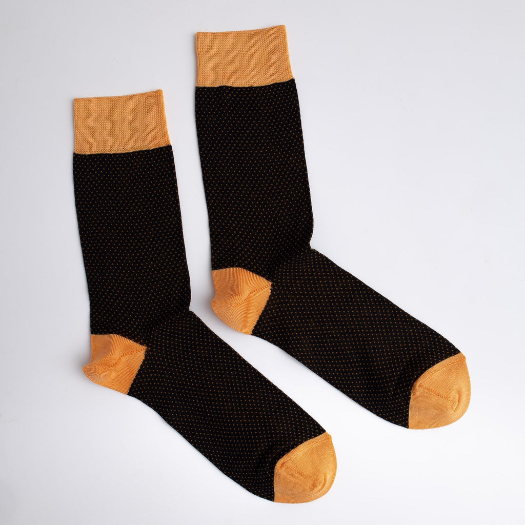 Black socks with orange accents on a light gray background


