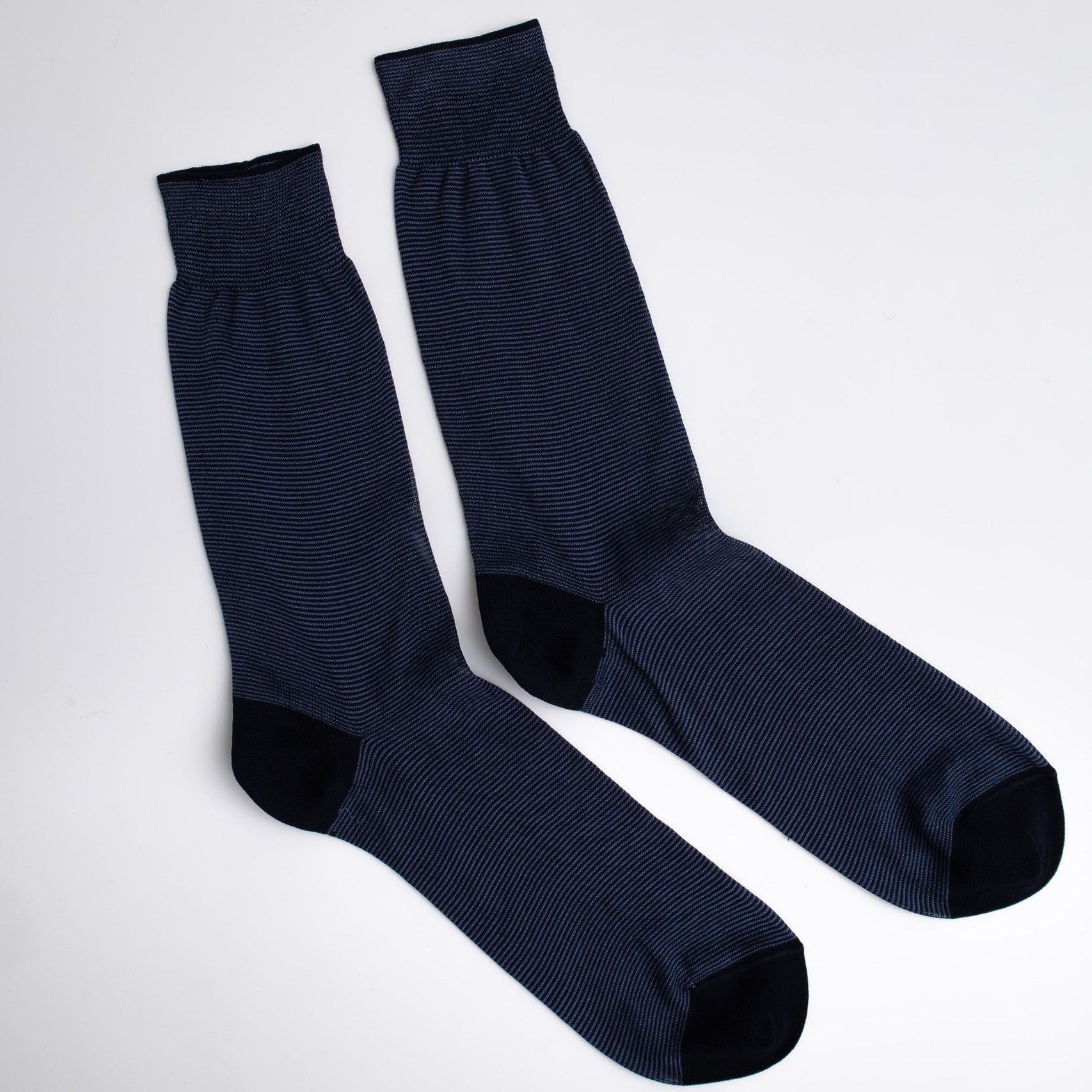 Pair of dark blue socks on a light gray background

