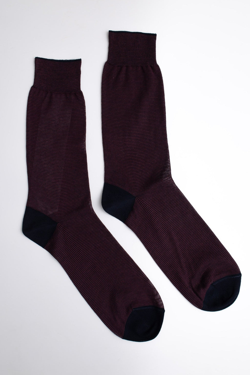 Pair of dark brown socks on a white background

