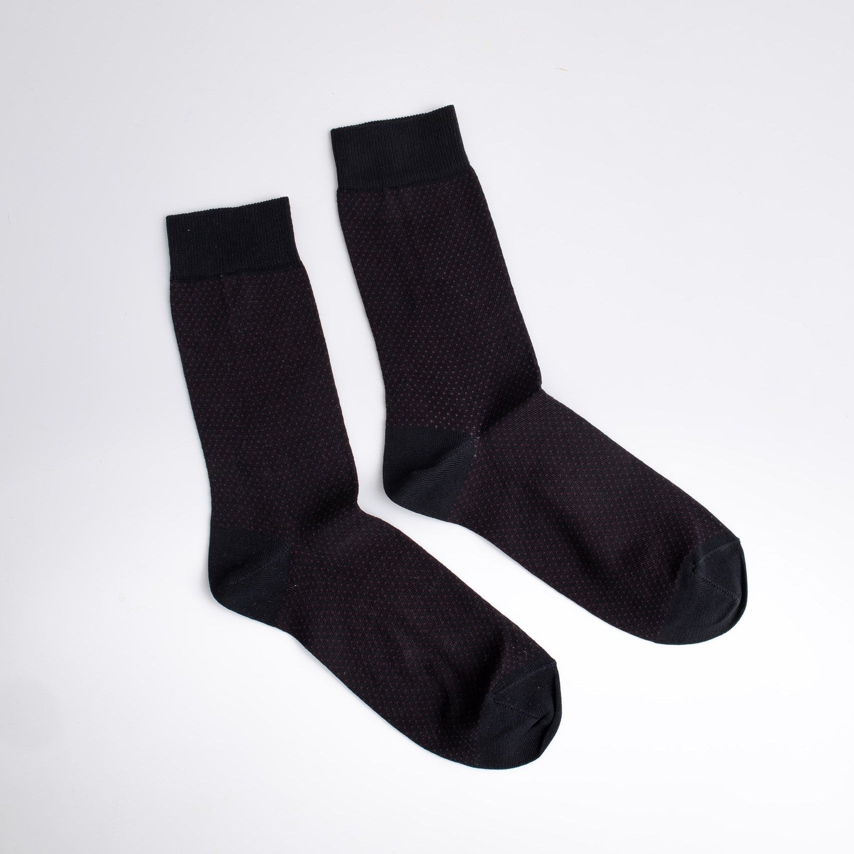 Pair of black socks on a white background

