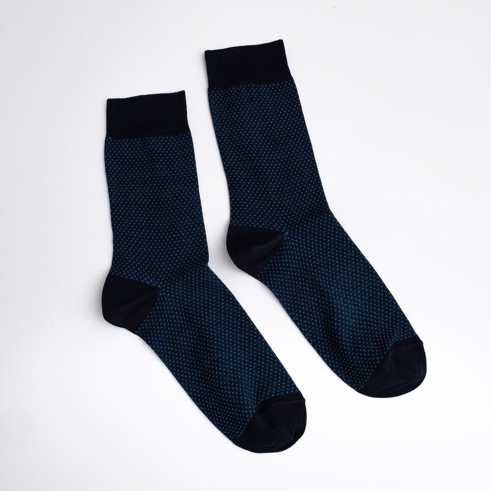 Pair of dark blue socks with black accents on a white background

