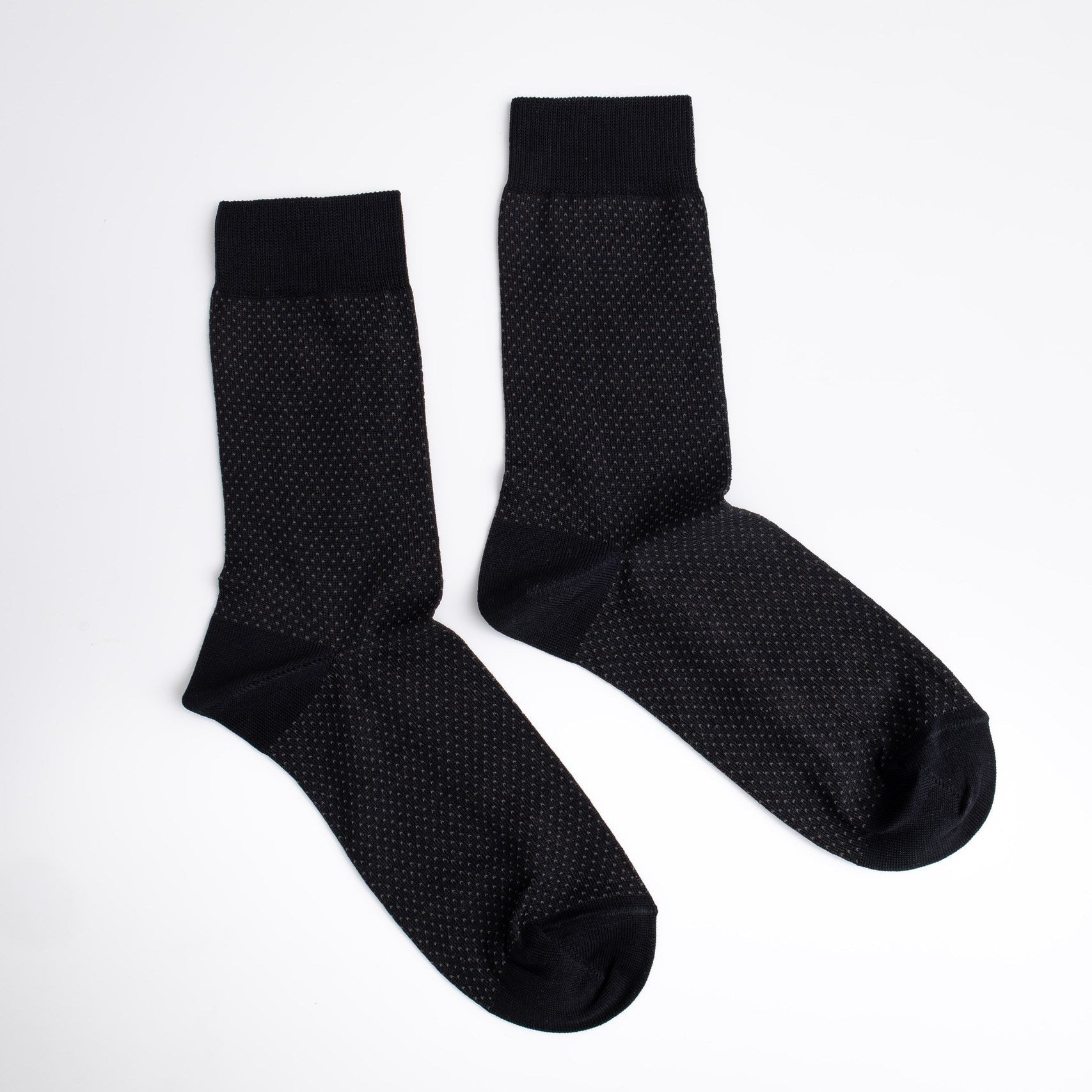 Pair of black textured socks on a white background

