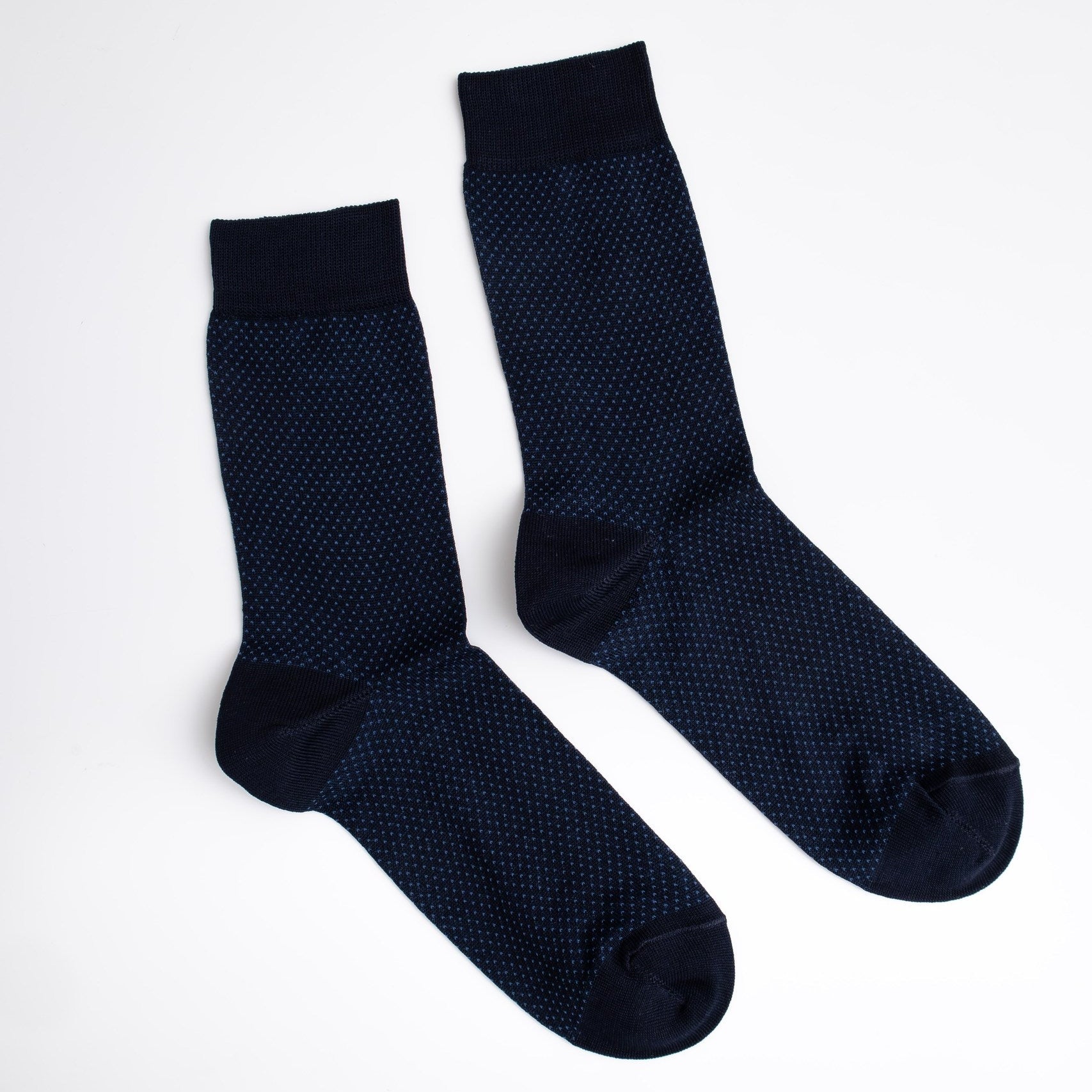 Pair of dark blue textured socks on a white background

